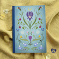 Load image into Gallery viewer, Notebook with floral design on a textured yellow fabric background
