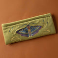 Load image into Gallery viewer, Embroidered pouch with a moth design on a brown background