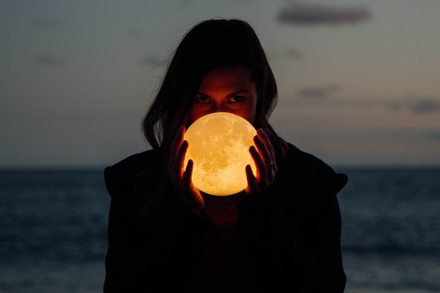 lady holding the moon wondering when the right time to cut her hair