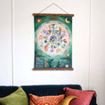 Load image into Gallery viewer, moon phase calendar on a wall with hangers
